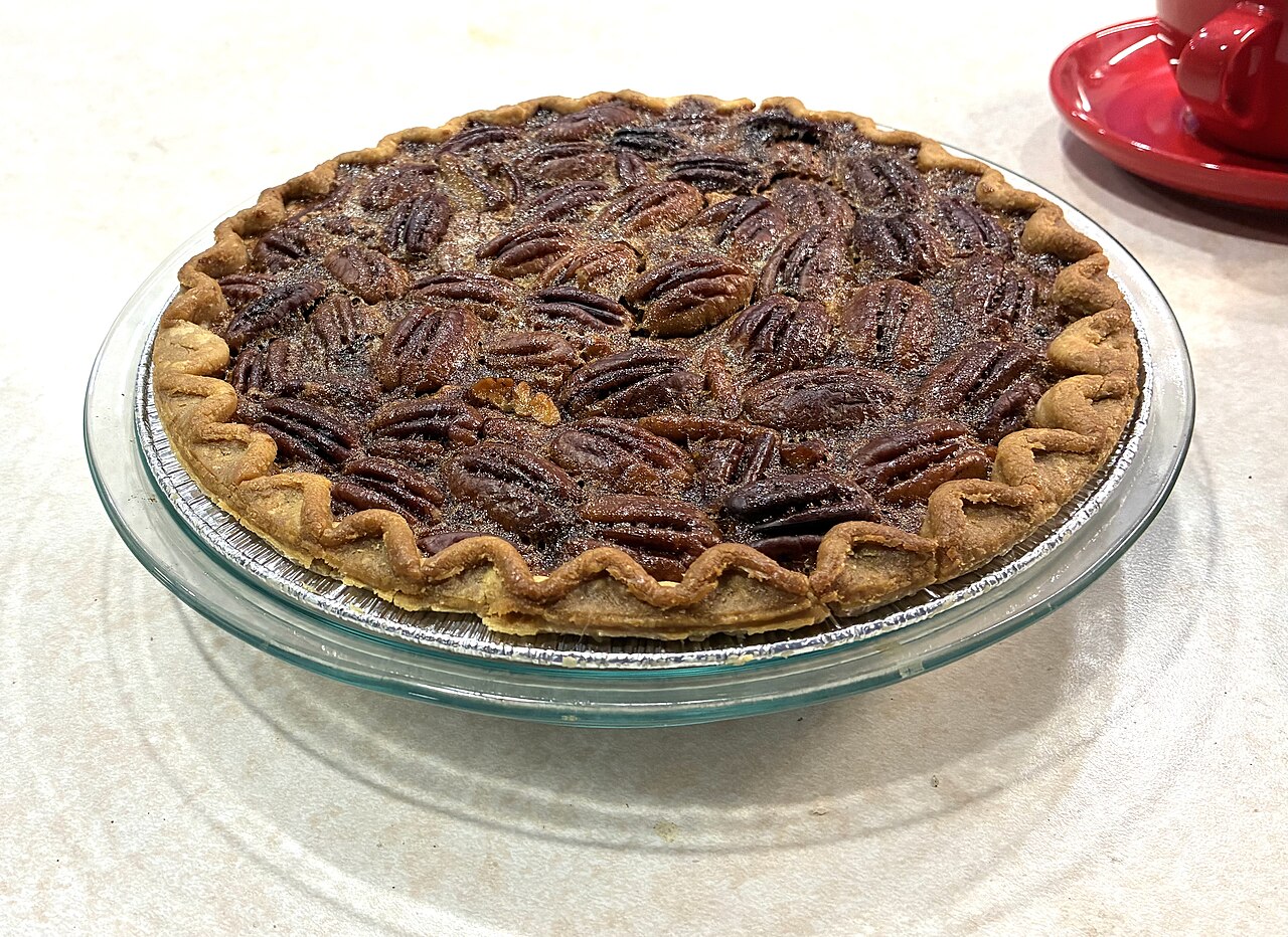 A maple-bourbon pecan pie, its top packed with glossy toasted pecans.